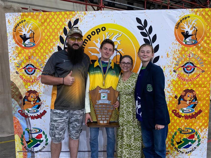 boy with accolade and his family.