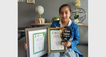 Girl in school uniform and with many trophies