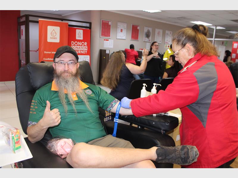 man with beard donate blood