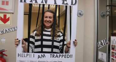 woman behind fake prison bars
