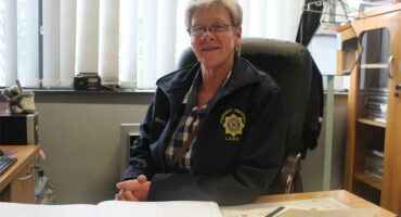 police officer sits behind a desk