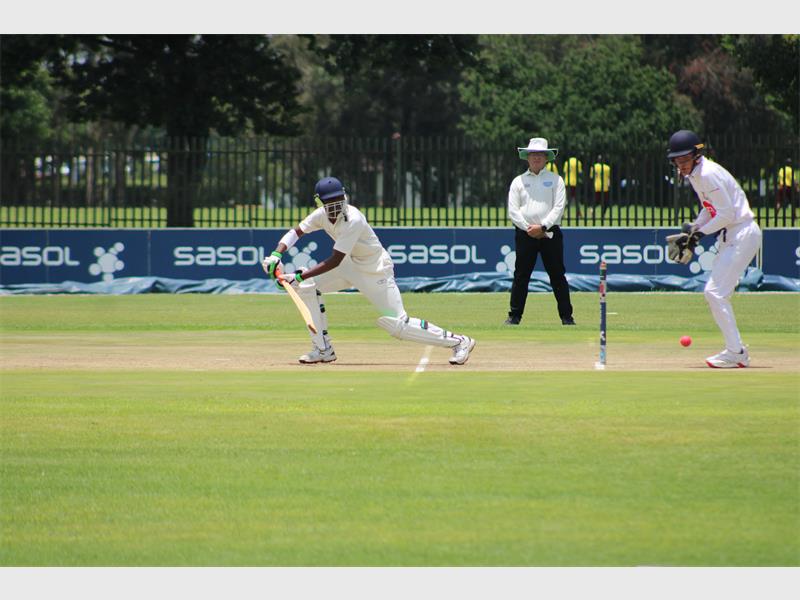 A senior cricket player bats