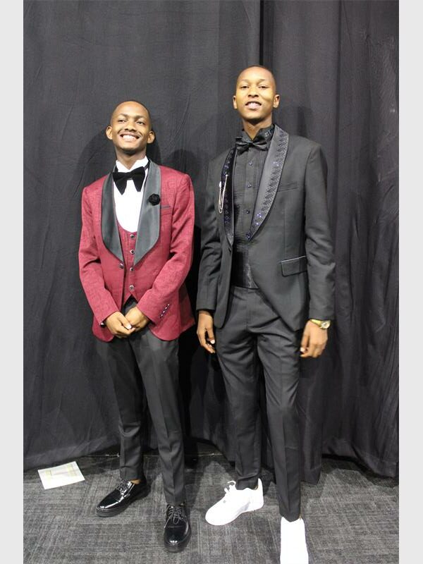 two boys dressed in tuxedos