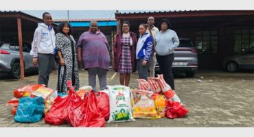 six people with shopping packages