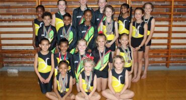 Group of children in gymnastics clothes