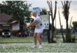 woman plays golf on course that is full of hail