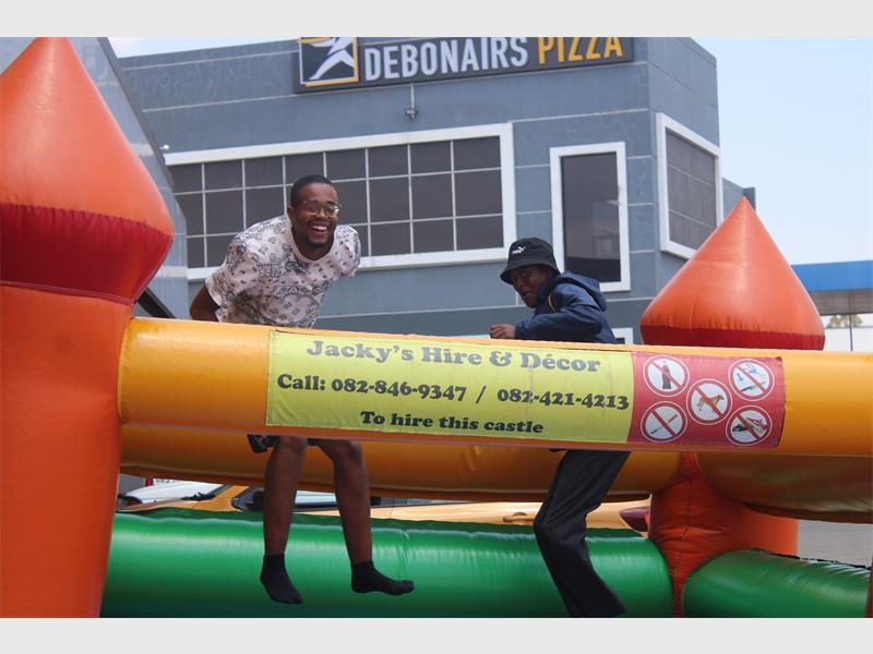 two men on a bouncing castle