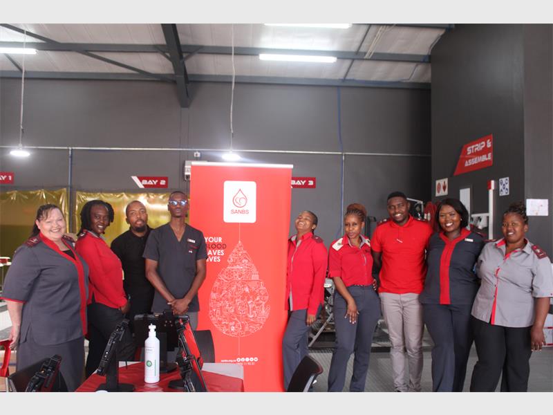 team of workers wearing red shirts