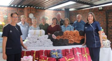 large group of people with gifts in front of them