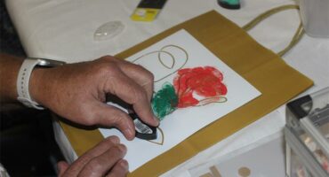 A woman decorates a bag