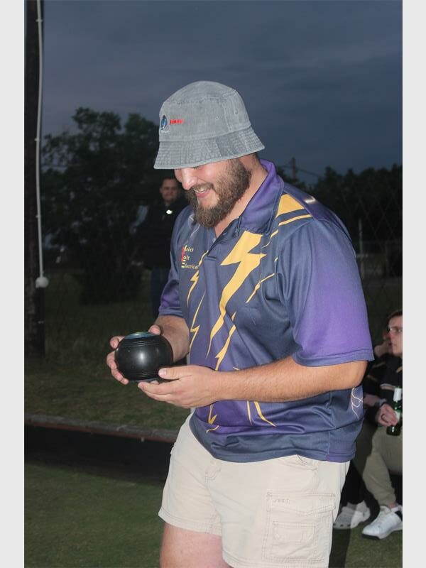 bowls player holds wood in hand