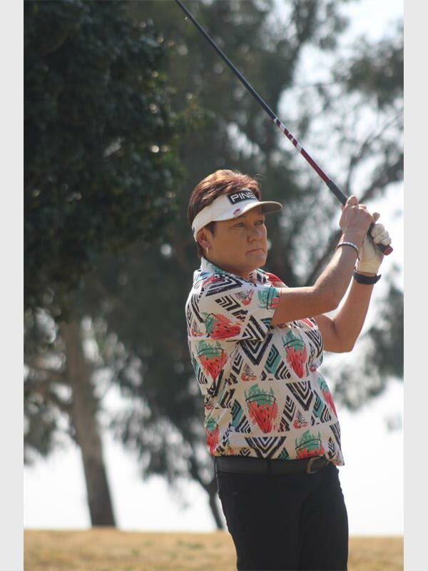A woman plays golf