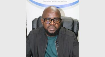 man sit with interlocking fingers