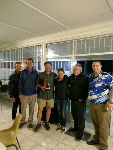 Six people with a trophy