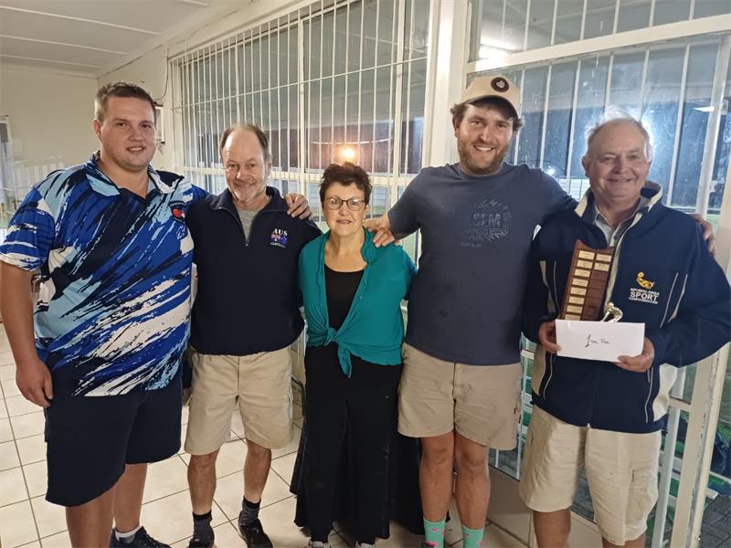 Five people with a trophy
