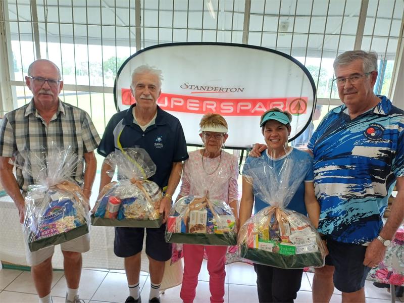 Five people with gift hampers