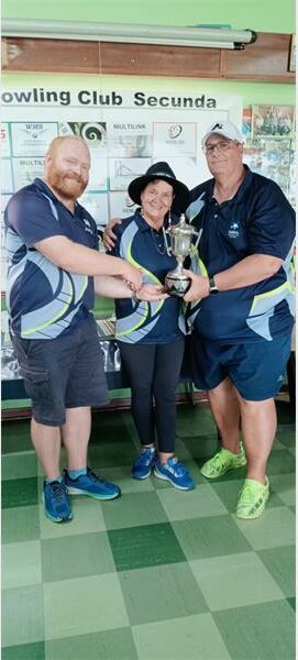 Three people holding up a trophy
