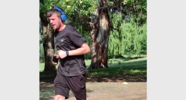 Man with earphones runs