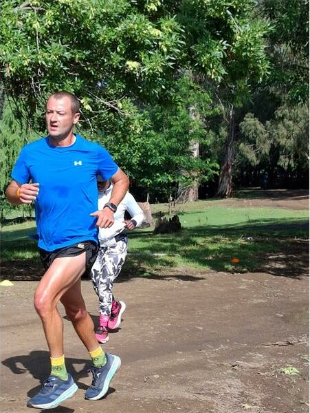 Man in blue shirt runs