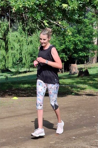 Woman in black vest and ski pants runs