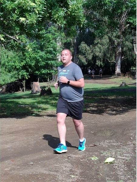 Man in grey T -shirt runs