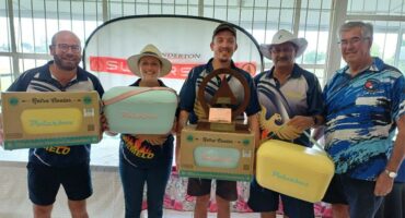 five people with cooler boxes