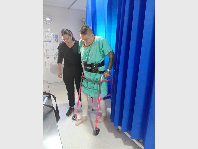 man walks with crutches