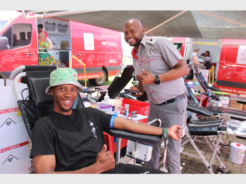 male nurse helps man to donate blood