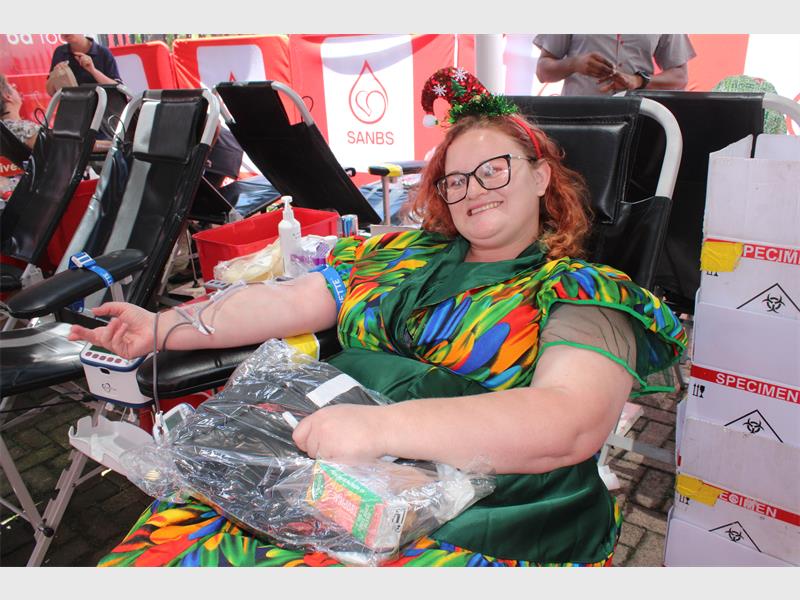 woman in colourful dress donating blood
