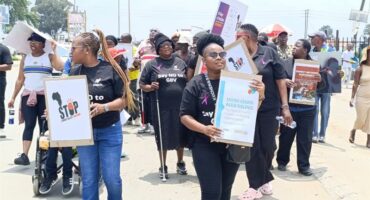 people walk with posters