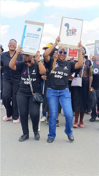 women hold up posters during a march