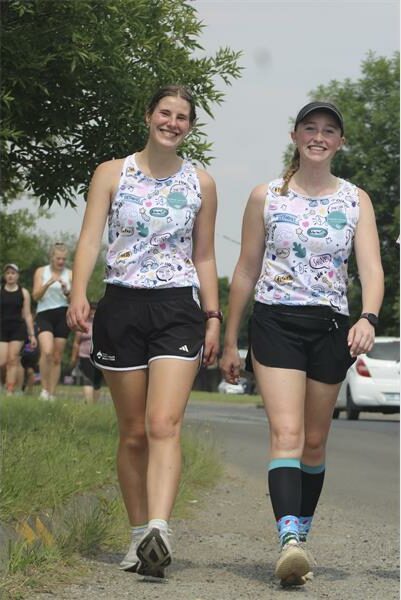 two girls walking in similar outfits