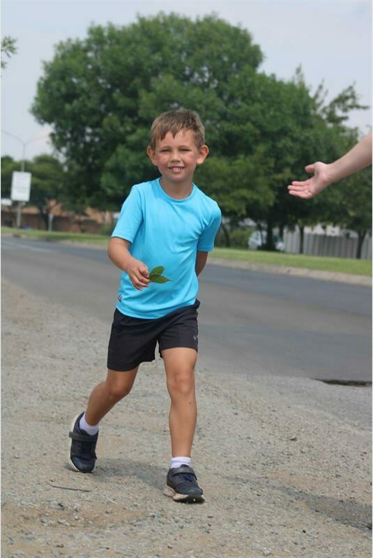 little boy in blue walks in the road