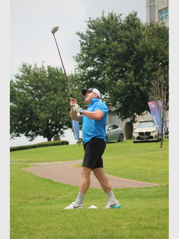 A man tees off on the golf course