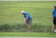 a golf player hits the ball