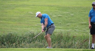 a golf player hits the ball