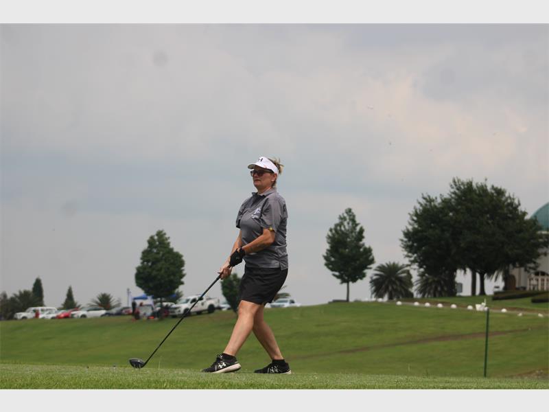 a woman with a golf club