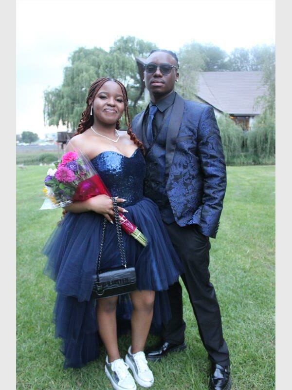 girl in blue dress and sneakers and boy in matching suit