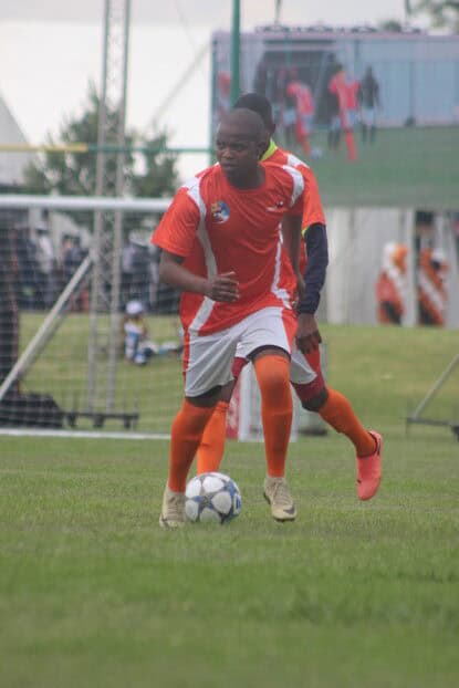 New Denmark player dribbles the ball.