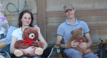 two people with teddies