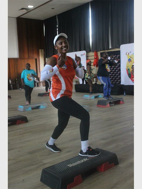 woman shows thumbs up in fitness session