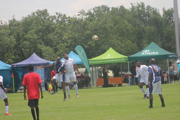 Two players try to headbutt the ball simultaneously.