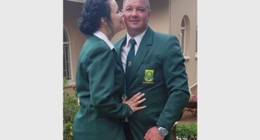 woman kisses husband on the cheek