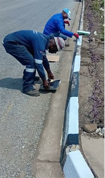 Volunteers of the Kinross Community Forum work on the flower beds in the main street in Kinross.