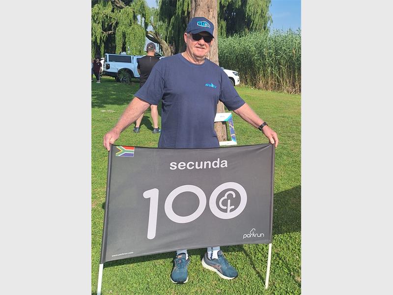 man with a banner with 100 on it