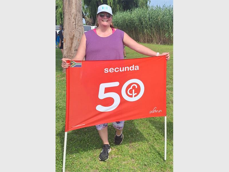 woman with a 50th banner