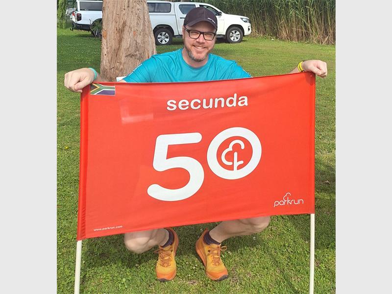 man with 50th banner