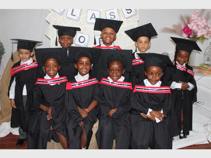 group of children in graduation gowns