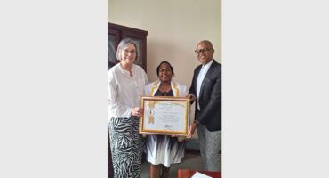 Three people with an accolade