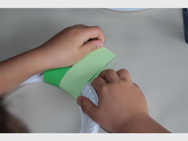 folding strips of green paper